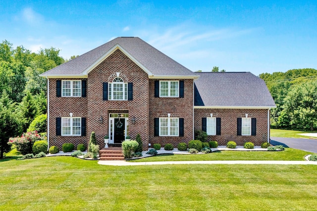 1258 Colby Dr, Forest, VA 24551 - colonial house with a front yard, roof with shingles, and brick siding