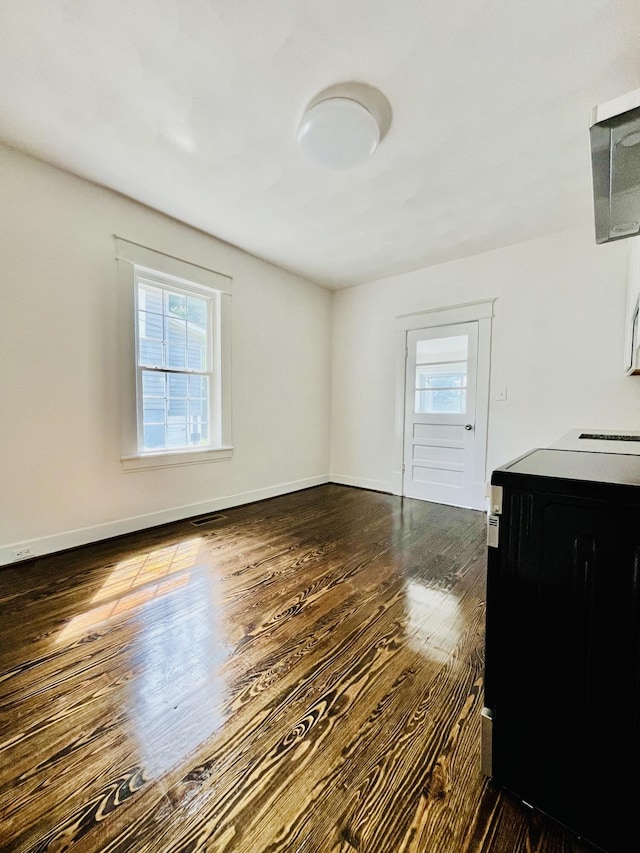 1138 Murray Ave SE, Roanoke, VA 24013 - unfurnished living room featuring dark wood-type flooring and baseboards