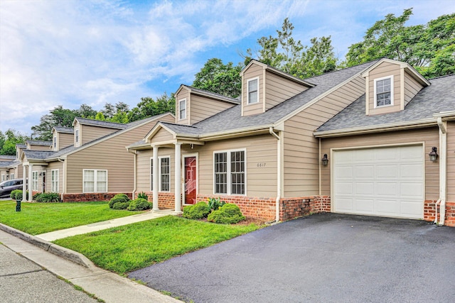 6617 Hartman Ct, Roanoke, VA 24019 - cape cod-style house with brick siding, a front yard, an attached garage, and asphalt driveway