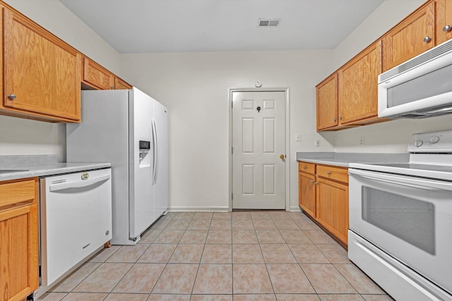 6617 Hartman Ct, Roanoke, VA 24019 - kitchen with white appliances, light countertops, and light tile patterned floors