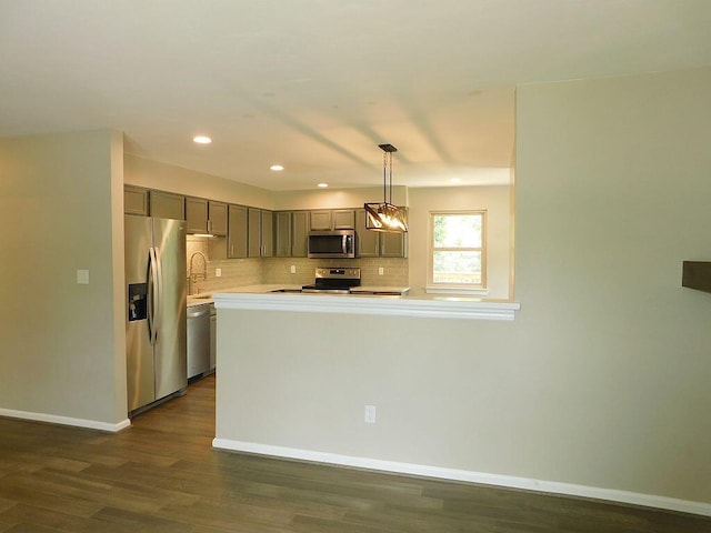 4230 Belford St SW, Roanoke, VA 24018 - kitchen featuring appliances with stainless steel finishes, light countertops, gray cabinets, tasteful backsplash, and dark wood finished floors