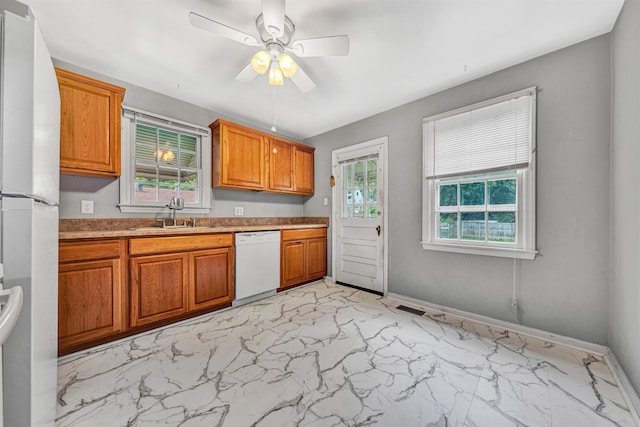 755 Brandon Ave SW, Roanoke, VA 24015 - kitchen featuring white appliances, light marble finish flooring, ceiling fan, brown cabinetry, and light countertops