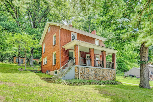 1831 S Carpenter Dr, Covington, VA 24426 - view of front of property featuring a chimney, a front lawn, a porch, and brick siding