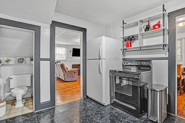 1831 S Carpenter Dr, Covington, VA 24426 - kitchen with black range with electric stovetop and freestanding refrigerator