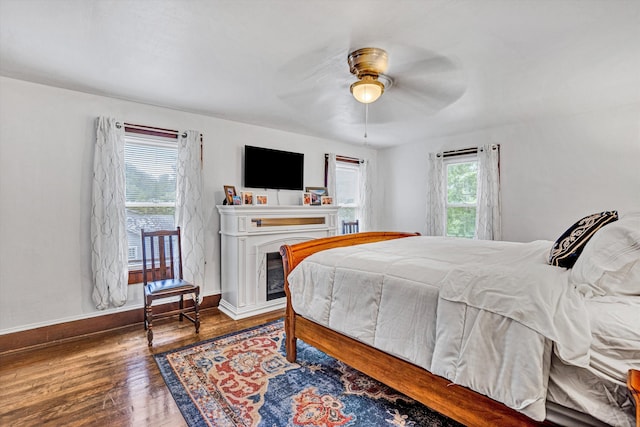 1831 S Carpenter Dr, Covington, VA 24426 - bedroom with wood finished floors, ceiling fan, and a glass covered fireplace