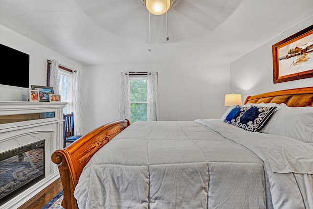 1831 S Carpenter Dr, Covington, VA 24426 - bedroom with multiple windows, wood finished floors, a fireplace, and ceiling fan