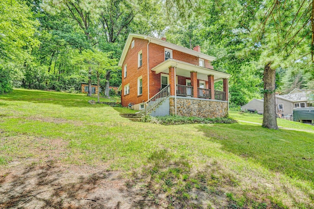 1831 S Carpenter Dr, Covington, VA 24426 - view of front of property with a chimney, a porch, a front lawn, and brick siding