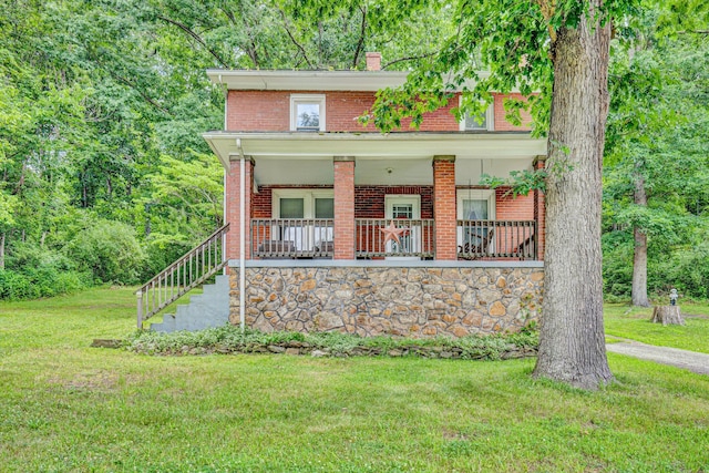 1831 S Carpenter Dr, Covington, VA 24426 - view of front of home with brick siding, a front yard, covered porch, a chimney, and stairs