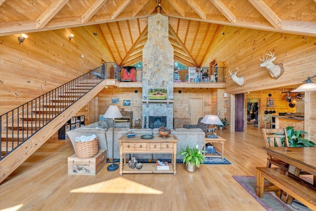1769 Scenic View Rd, Moneta, VA 24121 - living area featuring a wood ceiling with exposed beams, high vaulted ceiling, wooden walls, stairway, and wood finished floors
