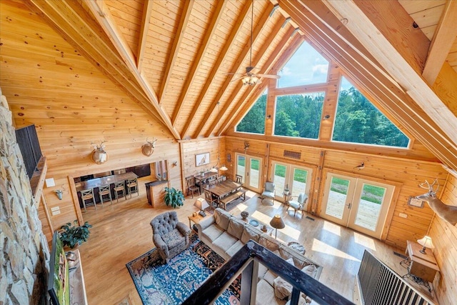 1769 Scenic View Rd, Moneta, VA 24121 - living room featuring wood walls, high vaulted ceiling, french doors, a wood ceiling with exposed beams, and plenty of natural light