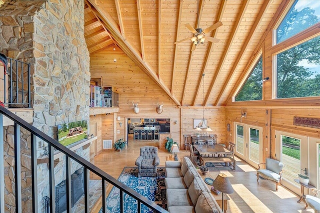 1769 Scenic View Rd, Moneta, VA 24121 - living area with a wooden ceiling with exposed beams, high vaulted ceiling, wood walls, healthy amount of natural light, and ceiling fan