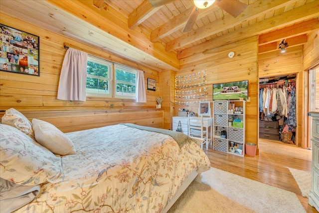 1769 Scenic View Rd, Moneta, VA 24121 - bedroom featuring a wooden ceiling with exposed beams, wooden walls, wood finished floors, a closet, and a walk in closet