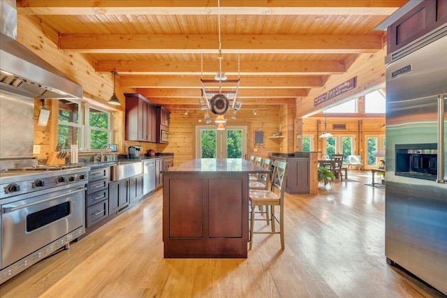 1769 Scenic View Rd, Moneta, VA 24121 - kitchen featuring premium appliances, range hood, wooden walls, light wood-style flooring, and a wood ceiling with exposed beams