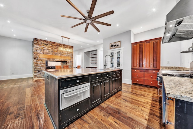 3150 Green Ridge Rd NW, Roanoke, VA 24019 - kitchen with wall chimney exhaust hood, stove, ceiling fan, a warming drawer, and open floor plan