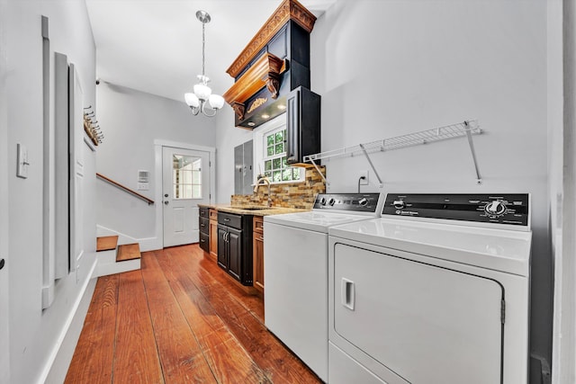 3150 Green Ridge Rd NW, Roanoke, VA 24019 - laundry area featuring washer and clothes dryer, dark wood-type flooring, and a chandelier