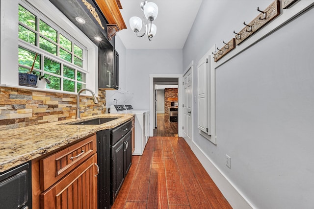 3150 Green Ridge Rd NW, Roanoke, VA 24019 - kitchen with washing machine and dryer, tasteful backsplash, light stone counters, dark wood-style flooring, and a chandelier