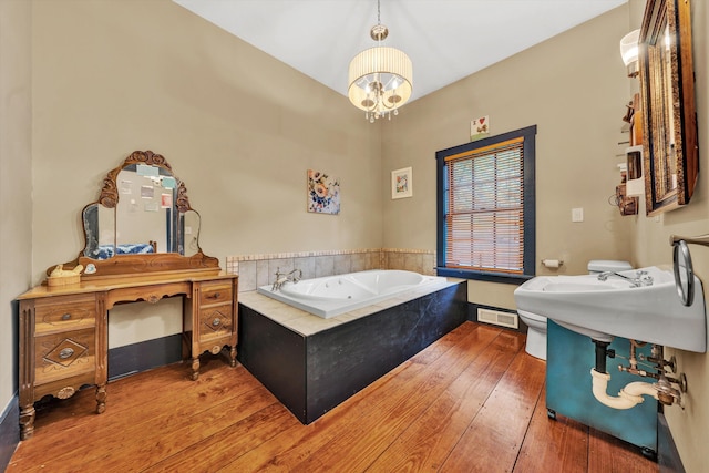 3150 Green Ridge Rd NW, Roanoke, VA 24019 - full bath with a chandelier, a jetted tub, and hardwood / wood-style floors