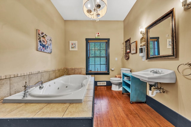 3150 Green Ridge Rd NW, Roanoke, VA 24019 - bathroom featuring a jetted tub and wood finished floors