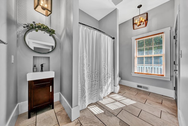 3150 Green Ridge Rd NW, Roanoke, VA 24019 - full bathroom with vanity, a chandelier, and a shower with shower curtain