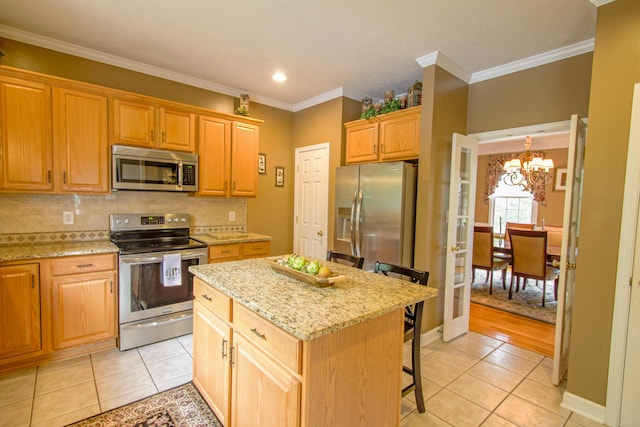 1266 Wills Way, Forest, VA 24551 - kitchen featuring stainless steel appliances, a chandelier, light tile patterned floors, a kitchen bar, and a center island
