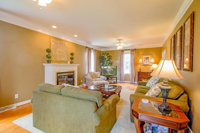 1266 Wills Way, Forest, VA 24551 - living room with crown molding, light wood-style floors, a glass covered fireplace, ceiling fan, and recessed lighting