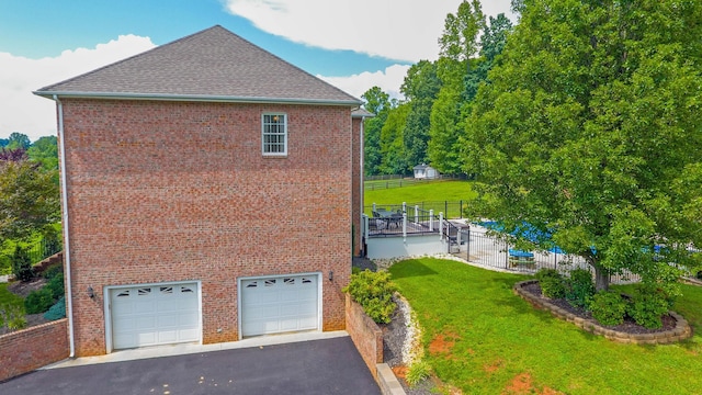 1266 Wills Way, Forest, VA 24551 - view of side of home with an attached garage, asphalt driveway, brick siding, and roof with shingles