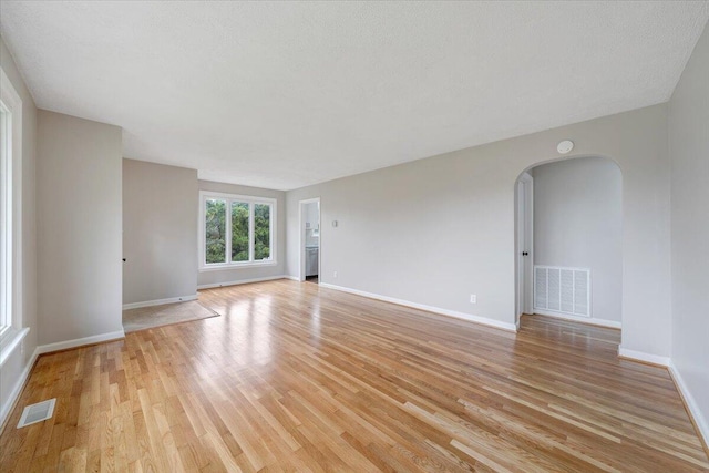 1709 Coveland Dr NW, Roanoke, VA 24017 - spare room with light wood finished floors and arched walkways