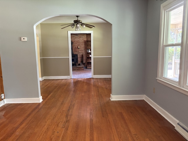 713 Rose Ave, Covington, VA 24426 - corridor featuring a baseboard radiator, arched walkways, and wood finished floors