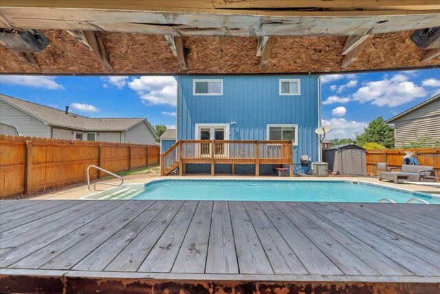 3341 Fort Lewis Cir, Salem, VA 24153 - view of swimming pool featuring a deck, a shed, a fenced backyard, and french doors