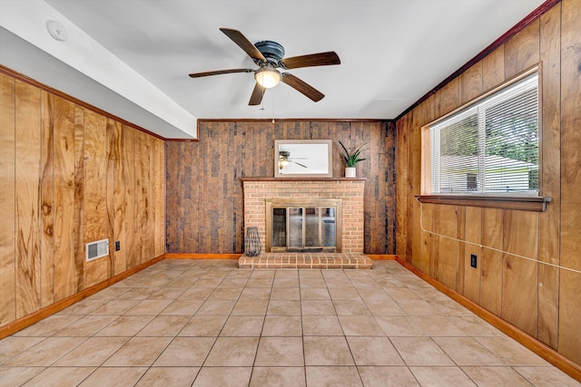 3716 Bower Rd, Roanoke, VA 24018 - unfurnished living room featuring a ceiling fan, a fireplace, wooden walls, and light tile patterned flooring
