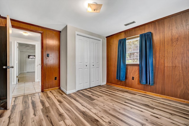 3716 Bower Rd, Roanoke, VA 24018 - unfurnished bedroom featuring wooden walls, a closet, and light wood-style floors