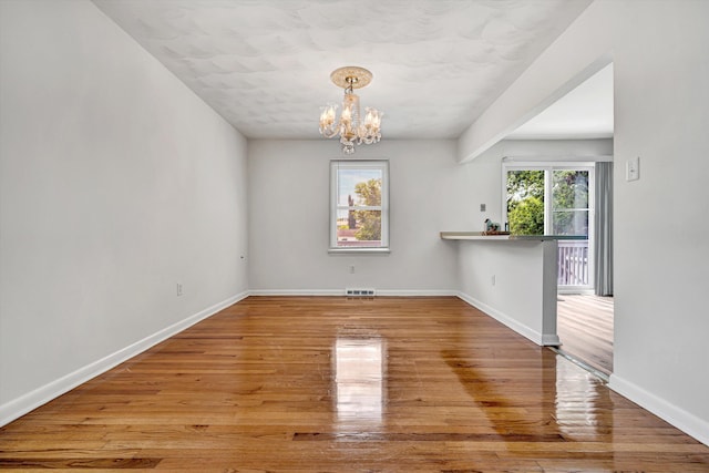 3716 Bower Rd, Roanoke, VA 24018 - unfurnished dining area featuring a chandelier and wood finished floors