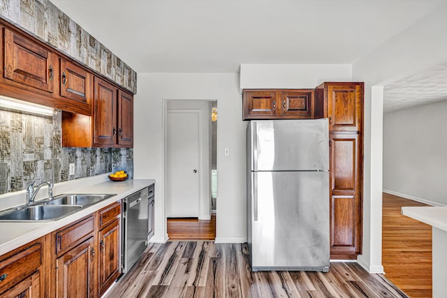 3716 Bower Rd, Roanoke, VA 24018 - kitchen featuring appliances with stainless steel finishes, wood finished floors, light countertops, and decorative backsplash