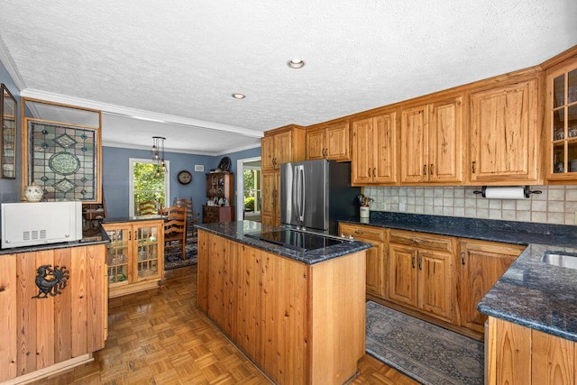 420 Cresthill Rd, Lynchburg, VA 24504 - kitchen with freestanding refrigerator, black electric cooktop, a kitchen island, ornamental molding, and white microwave