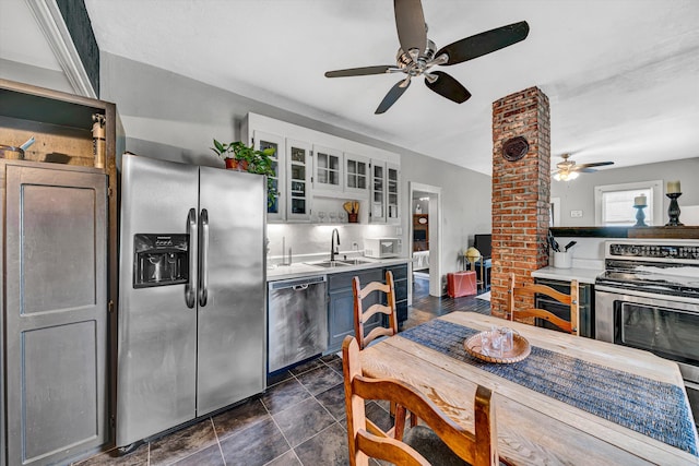 1521 Church Ave SE, Roanoke, VA 24013 - kitchen with appliances with stainless steel finishes, ceiling fan, decorative columns, glass insert cabinets, and light countertops