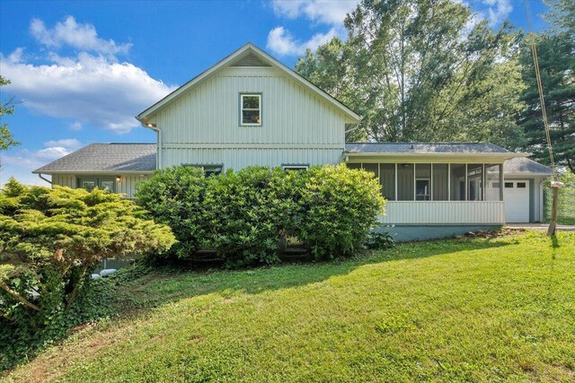 404 Robin Ridge Rd, Rocky Mount, VA 24151 - view of property exterior featuring a sunroom, a lawn, and an attached garage