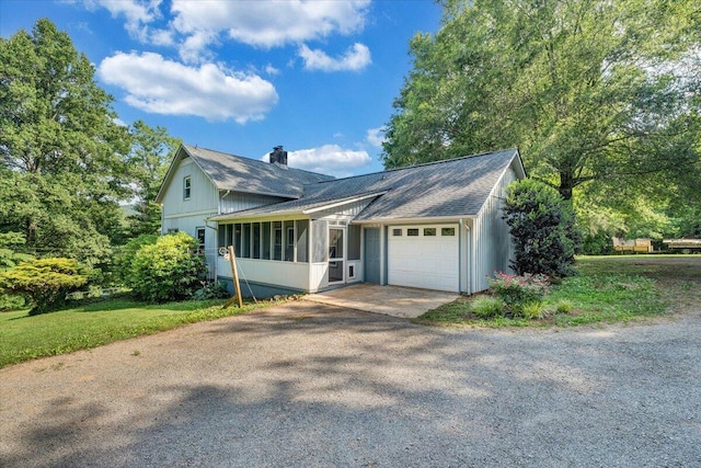 404 Robin Ridge Rd, Rocky Mount, VA 24151 - view of front of house with driveway, an attached garage, a chimney, a sunroom, and roof with shingles