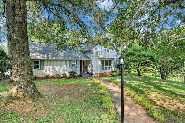 404 Robin Ridge Rd, Rocky Mount, VA 24151 - view of front of house featuring roof with shingles, a front lawn, and board and batten siding