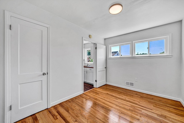 3113 Birchlawn Ave NW, Roanoke, VA 24012 - unfurnished bedroom featuring light wood-type flooring and ensuite bath
