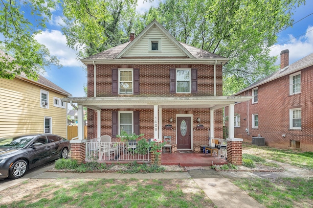1406 Melrose Ave NW, Roanoke, VA 24017 - american foursquare style home featuring a porch, brick siding, and a chimney