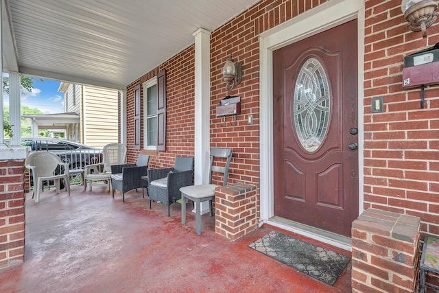 1406 Melrose Ave NW, Roanoke, VA 24017 - doorway to property featuring covered porch and brick siding