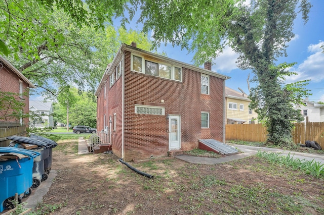 1406 Melrose Ave NW, Roanoke, VA 24017 - rear view of property with a chimney, brick siding, and entry steps