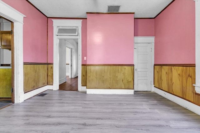 610 18th St SE, Roanoke, VA 24013 - unfurnished bedroom with wainscoting, ornamental molding, wood finished floors, and wooden walls