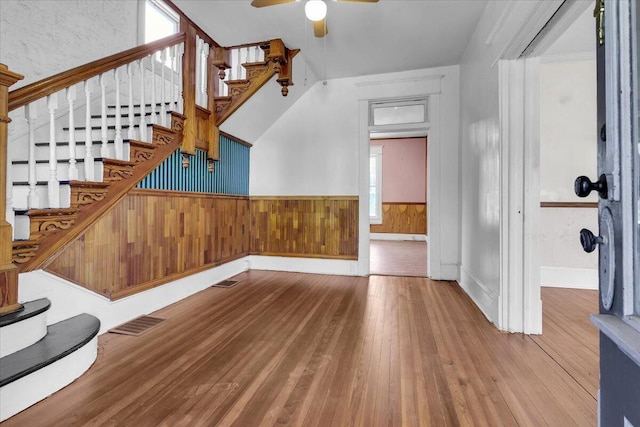 610 18th St SE, Roanoke, VA 24013 - foyer with wainscoting, wood-type flooring, a ceiling fan, stairway, and wood walls