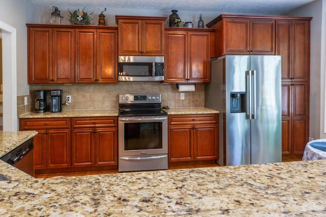 115 Armistead Ln, Rustburg, VA 24588 - kitchen featuring stainless steel appliances, light stone countertops, decorative backsplash, and brown cabinets