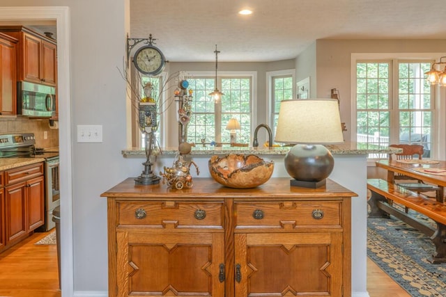 115 Armistead Ln, Rustburg, VA 24588 - kitchen with appliances with stainless steel finishes, brown cabinetry, light wood finished floors, decorative light fixtures, and recessed lighting