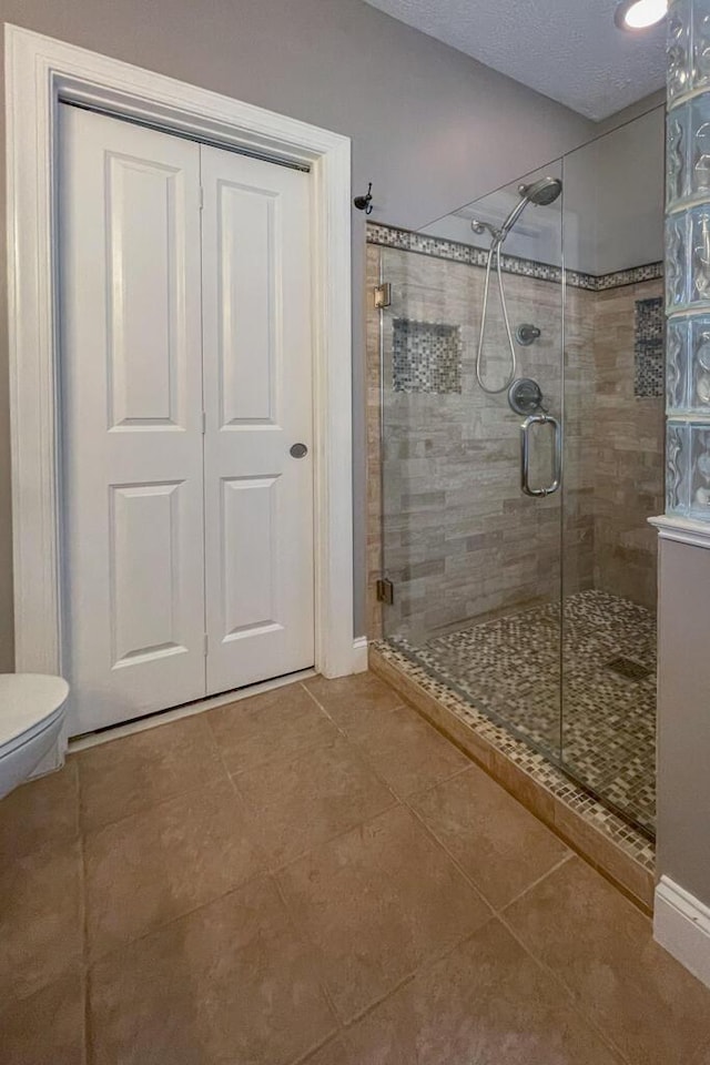 115 Armistead Ln, Rustburg, VA 24588 - bathroom featuring a stall shower, tile patterned flooring, and a textured ceiling