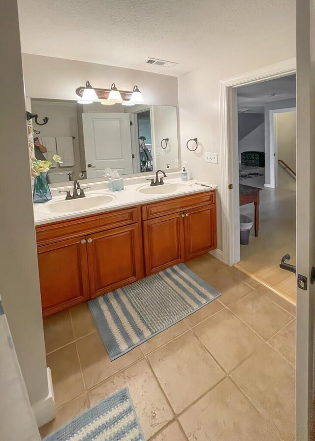 115 Armistead Ln, Rustburg, VA 24588 - bathroom with double vanity, tile patterned flooring, and a textured ceiling