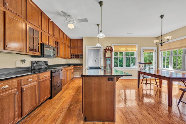 6820 Dawnwood Rd, Roanoke, VA 24018 - kitchen with black appliances, light wood-type flooring, and brown cabinetry