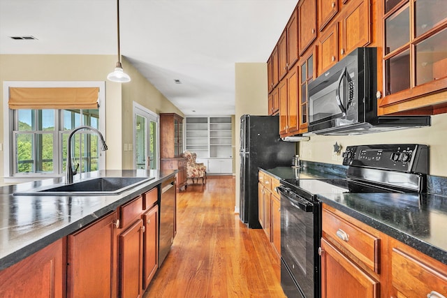 6820 Dawnwood Rd, Roanoke, VA 24018 - kitchen featuring black appliances, dark countertops, light wood finished floors, decorative light fixtures, and glass insert cabinets